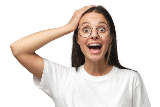 Young shocked woman in round glasses and white t-shirt shouting WOW with open mouth
