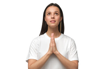 Young woman praying with hands pressed together, looking upwards as if asking god for blessing