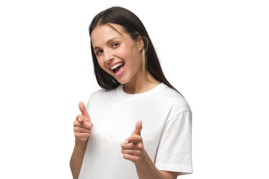 Close-up of young woman smiling with excitement and pointing to viewer