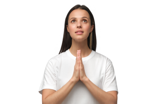 Young woman praying with hands pressed together, looking upwards as if asking god for blessing