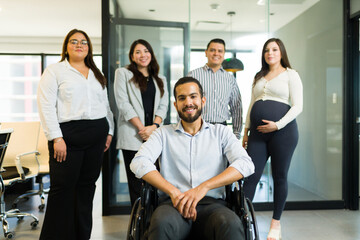 Disabled businessman with his colleagues in office