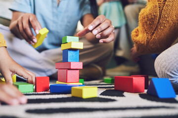 Hands, building blocks and color, learning and development with people at home playing games with toys. Relax on living room floor, parents and children with education activity, family and bonding