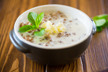 boiled buckwheat with milk and butter for breakfast, in a bowl