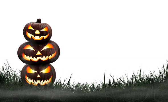 Three lit Jack-o-Lantern, halloween pumpkin lanterns on a dark nighttime grass with an isolated transparent background.