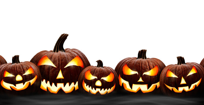 A group of five lit halloween lanterns on a dark table isolated against a transparent background.