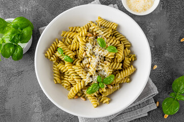 Fussili pasta with basil pesto sauce, parmesan cheese and pine nuts. Traditional Italian food.