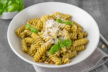 Fussili pasta with basil pesto sauce, parmesan cheese and pine nuts. Traditional Italian food.
