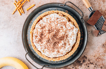 Banoffee pie with bananas, toffee, whipped cream and chocolate.