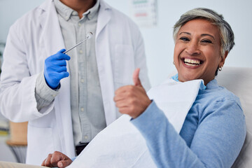 Happy woman, teeth and thumbs up for dentist in dental care, appointment or checkup at clinic. Senior female person smile with like emoji or yes sign in tooth whitening, cleaning mouth or gum care