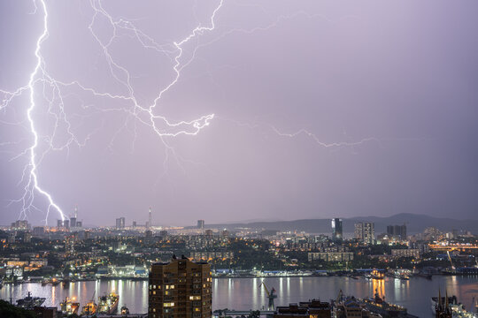 Thunderstorm with lightning over over cityscape.