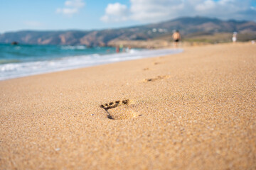 Footprints On Ocean Sandy Beach