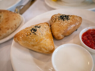 2 pieces of samosas on a white plate in tatar restaurant in Kyiv