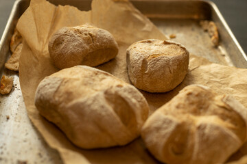 Closeup of home made bread on brown paper in a tray. Rural feel - 622297594