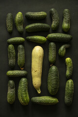 Flat lay with cucumbers and zucchini on dark background - 622297977