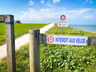 "Coastal path prohibited for bicycles" French sign on the coast of the Ré island in La Flotte, France