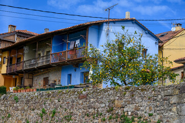 Travelling by car in Asturias, North of Spain. View on village, houses, gardens near Villaviciosa