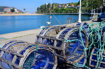 Fishing net with bucket for crayfish and crabs, Green coast of Asturias, Ribadesella village with sandy beaches, North of Spain