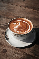 Selective focus cup of hot latte art coffee