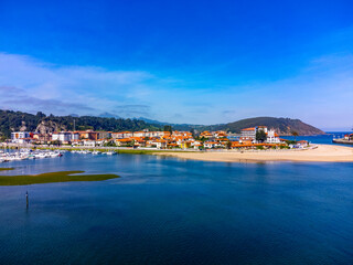 Naklejka na ściany i meble Aerial panoramic view, vacation on Costa Verde, Green coast of Asturias, Ribadesella village with sandy beaches, North of Spain
