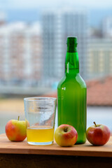 Traditional natural Asturian cider made from fermented apples in wooden barrels should be poured from great height for air bubbles into the drink and view on Gijon, Asturias, Spain