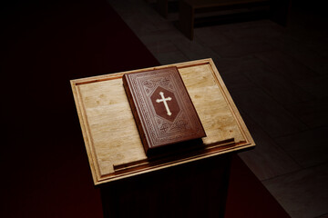 Beautiful Holy Bible on a wooden table against a bright white background. Gospel