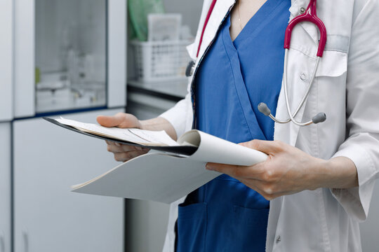 the doctor holds in his hands the results of the analysis of the patient, the conclusion of the doctor and the diagnosis