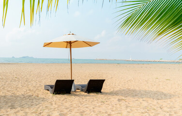 Beach chairs and umbrella in the beach.