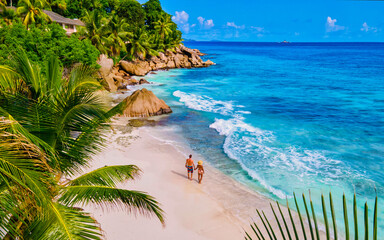 Anse Patates beach, La Digue Island, Seyshelles, Drone aerial view of La Digue Seychelles bird eye view.of tropical Island. mature couple men and women on vacation in Seychelles