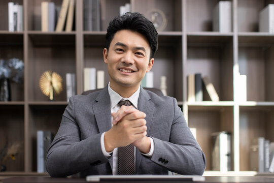 Successful Chinese businessman talking in office
