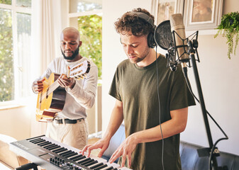 Piano, recording music and friends with guitar in home studio together. Electric keyboard,...