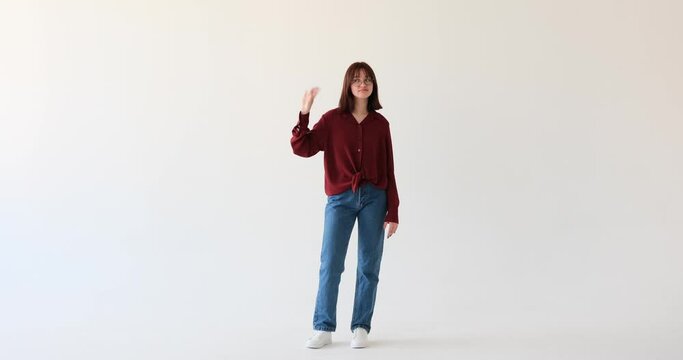 Teenage Caucasian girl as she stands against a pristine white background, showcasing her creative expression. Feeling a wave of boredom, she captivates viewers with her unique blah blah blah gesture.