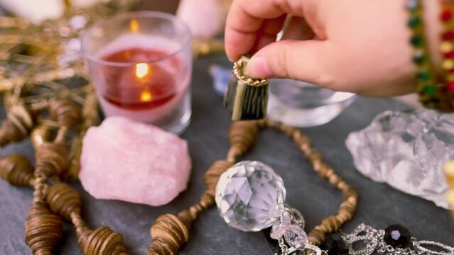 spiritualistic session in salon of soothsayer, fortune-teller, hands of female medium, alchemist, herbalist hold witchcraft potion, poison, elixir of youth, burning candles, spells, ritual magic