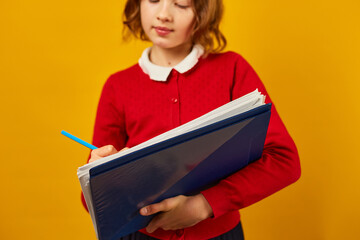 Thoughtful School teenage girl holding pen and write on notebook