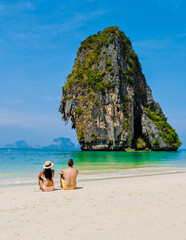 Fototapeta na wymiar a couple of men and women relaxing on the beach during a vacation in Thailand Railay Beach Krabi on a sunny day