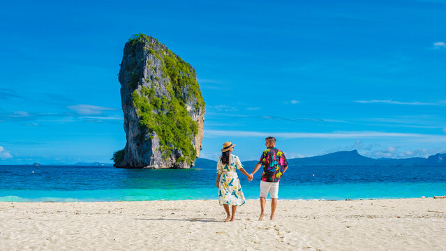 Koh Poda Krabi Thailand, Asian woman and European men walking on the tropical beach of Koh Poda Island Krabi Thailand. Beautiful tropical beach in Thailand