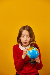 Stylish smiling school teenage girl holding magnifying glass in her hand