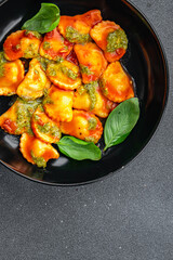 ravioli pesto sauce, tomato sauce meat pasta meal food snack on the table copy space food background rustic top view