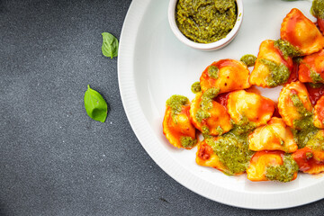 ravioli pesto sauce, tomato sauce meat pasta meal food snack on the table copy space food background rustic top view