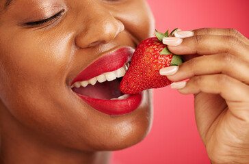 Strawberry, lipstick and woman lips eating, eco friendly product and color choice or dermatology. Happy mouth of african person or model with skincare, fruit and vegan makeup on studio red background