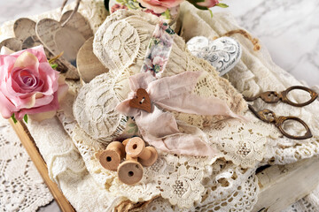 Wooden drawer with vintage sewing supplies and laces