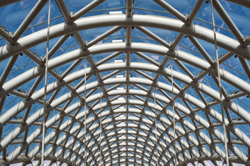 Close-up of a white metal arch with a glass roof