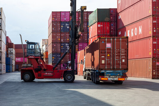 Istanbul, Beylikduzu - Turkey - 07.07.2023 Container yard for Logistic Import Export business, colorful container stack. view from moment of load. crane and loaded truck.