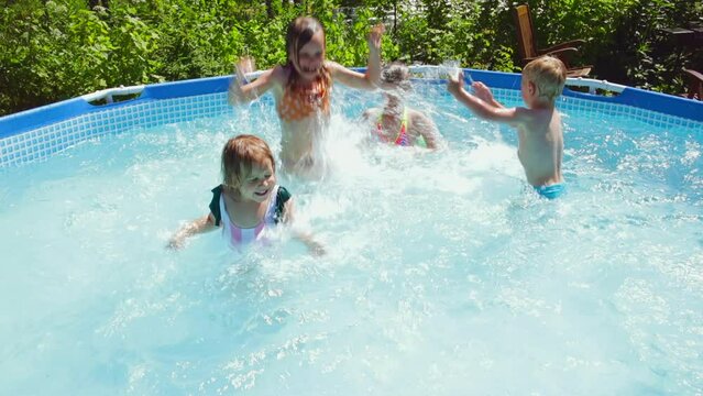 Happy children having fun in a pool splashing water kids_pool_6244