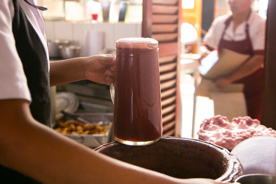 Preparation in clay pots of chicha morada, a fermented drink native to Peru.