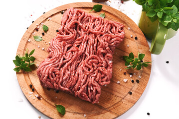 minced meat on a wooden cutting board. Isolated on white background