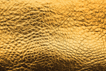 Golden textured surface as background, closeup view