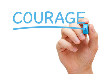 Hand writing Courage with blue marker on transparent wipe board.
