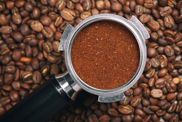 Espresso handle filled with ground coffee. Close up