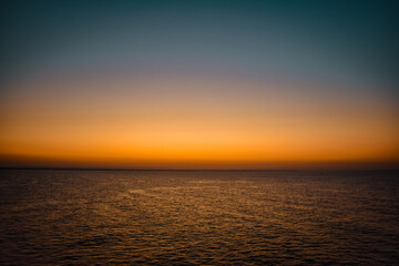 Sunrise sunset orange purple blue pink skies over ocean sea