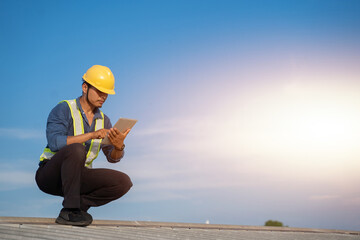 Engineer using tablet to inspect work at job site. concept of technology usage In industrial applications, remote data retrieval, large databases. network link. - 622328148